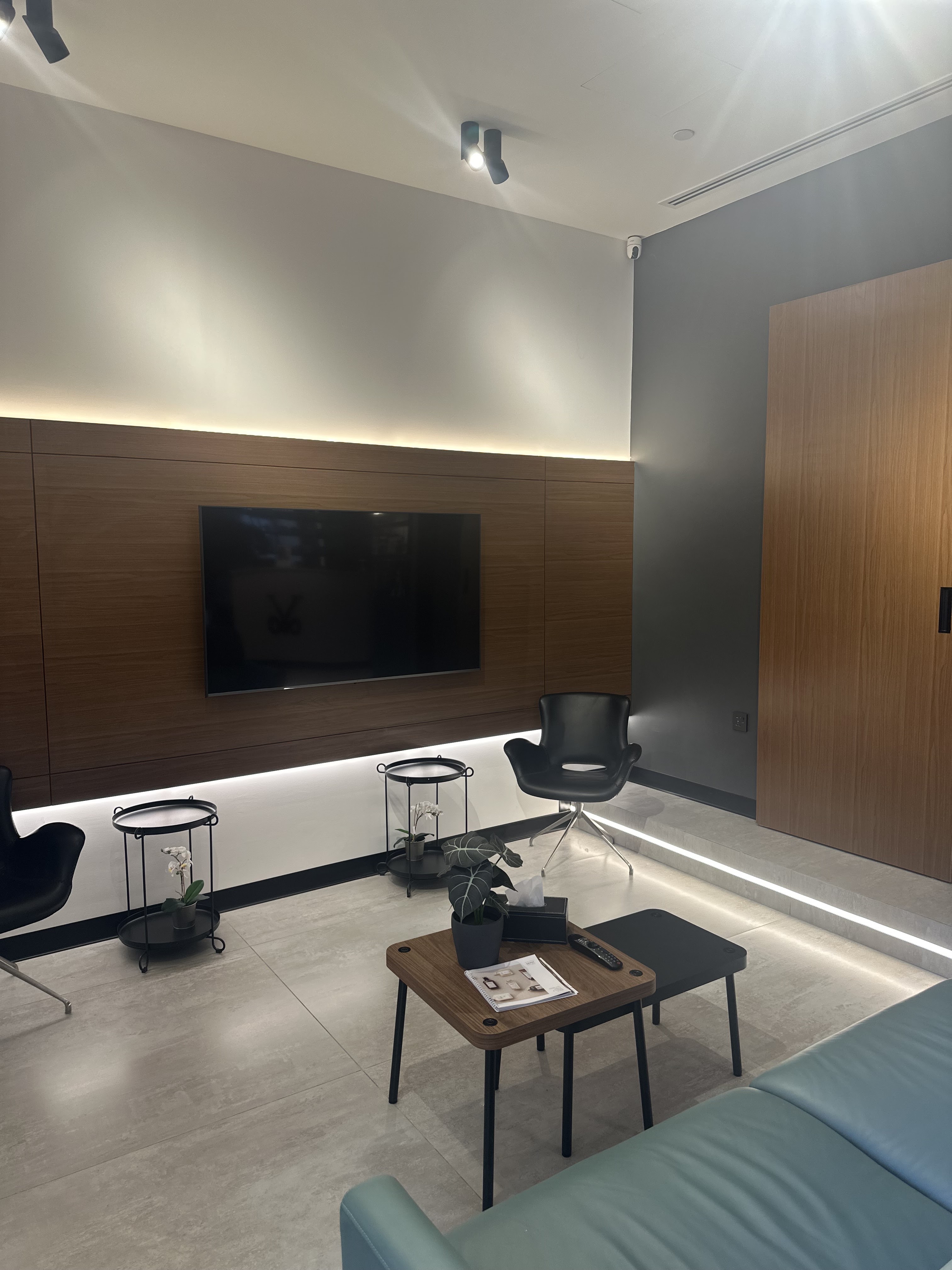 Full view of the lounge with sage leather seating and backlit steps