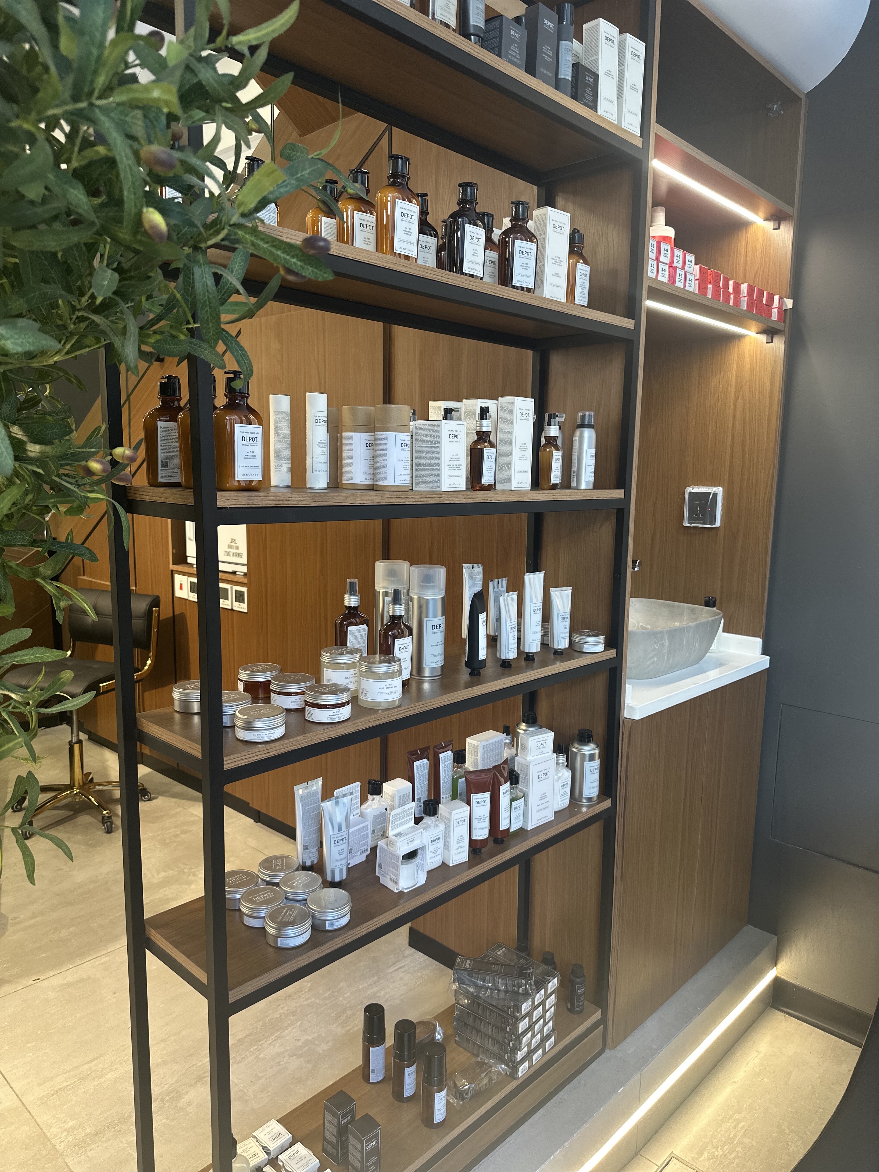 Shelves of Depot grooming products on display at Volume Gentlemen Barber & Spa